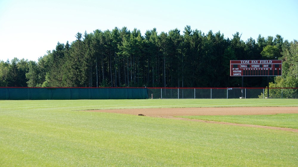 View of outfield with scoreboard from home dugout