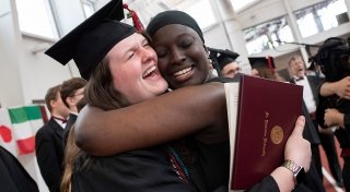 Students hugging at graduation
