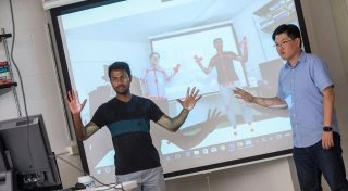 Student and faculty member demonstrating to a class