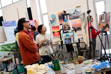 Faculty member and student looking at artwork