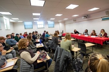 Students listening to alumni talk